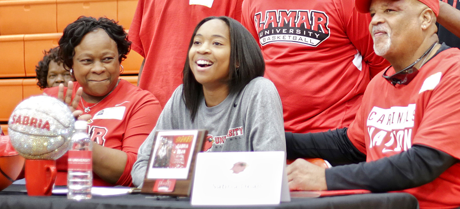 Mineola’s Sabria Dean accepted a full scholarship to Lamar University while flanked by her mother Sabrina Dean and her father James Dean, Jr.